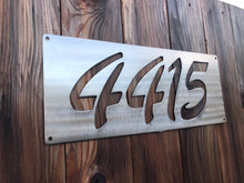 Load image into Gallery viewer, a close up of a sign on the side of a building