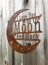 Load image into Gallery viewer, a sign that is on a wooden pole