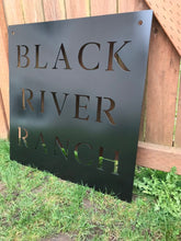 Load image into Gallery viewer, a sign that is sitting in front of a building