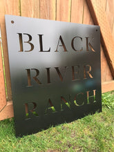 Load image into Gallery viewer, a sign that is sitting on a grass field