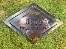 Load image into Gallery viewer, a sign that is sitting in the grass