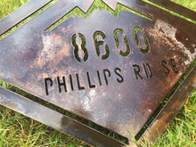 Load image into Gallery viewer, a sign on the side of the road