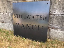 Load image into Gallery viewer, a sign on the side of a building