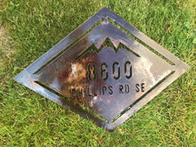 Load image into Gallery viewer, a sign that is sitting in the grass