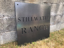 Load image into Gallery viewer, a sign on the side of a building
