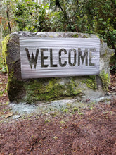 Load image into Gallery viewer, a white sign that is on the side of a road