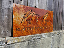 Load image into Gallery viewer, a sign on the side of a building