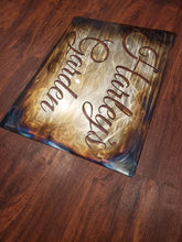 Load image into Gallery viewer, a book sitting on top of a wooden table