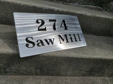 Load image into Gallery viewer, a sign that is sitting on the ground