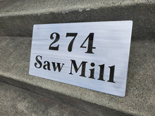 Load image into Gallery viewer, a sign on the side of a building