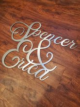 Load image into Gallery viewer, a pair of scissors sitting on top of a wooden table